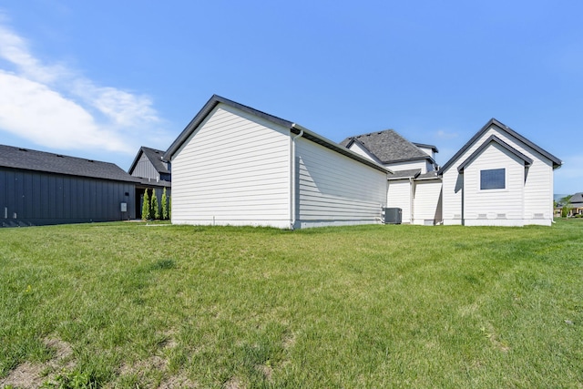 back of house with a yard and central AC unit