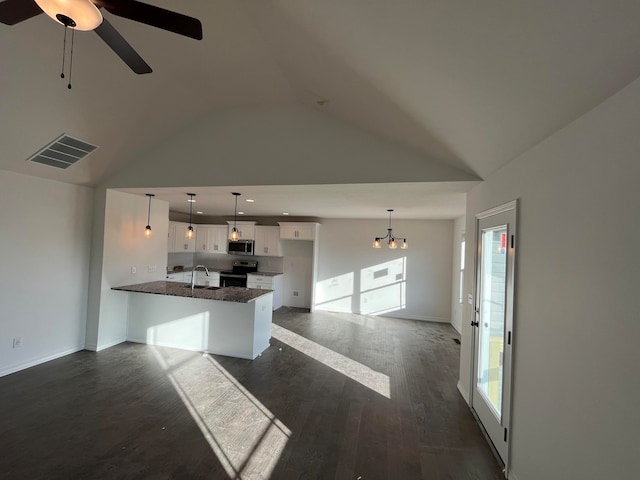 kitchen with white cabinets, dark hardwood / wood-style flooring, kitchen peninsula, appliances with stainless steel finishes, and decorative light fixtures