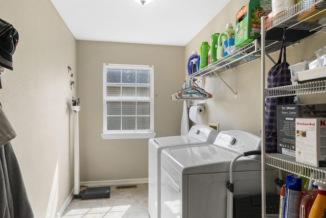 106 Willowbrooke, Branson, MO 65616 - clothes washing area featuring washing machine and clothes dryer, baseboards, visible vents, tile patterned flooring, and laundry area