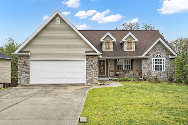 view of front of home with a garage, a front lawn, and covered porch