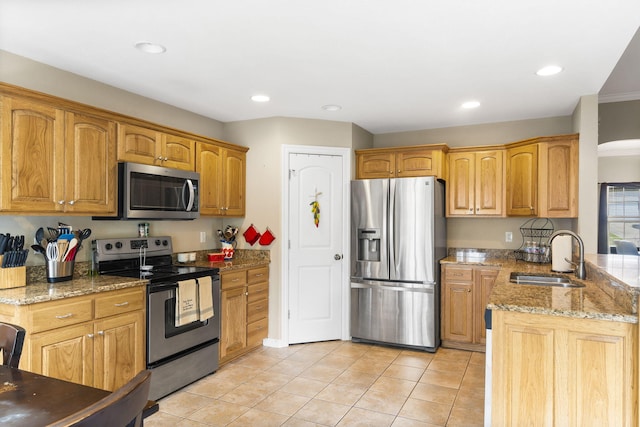 106 Willowbrooke, Branson, MO 65616 - kitchen with a sink, light tile patterned floors, a peninsula, appliances with stainless steel finishes, and light stone countertops