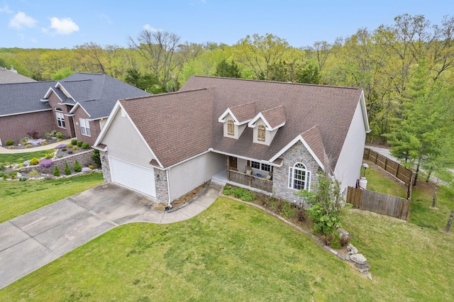 106 Willowbrooke, Branson, MO 65616 - view of front of home featuring stone siding, a front yard, covered porch, and fence