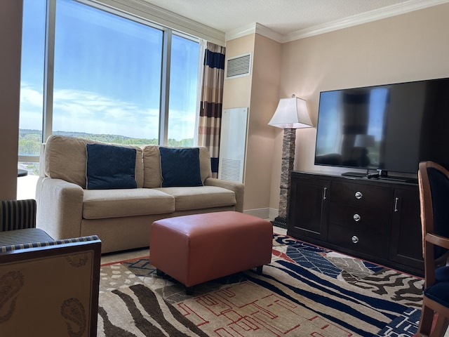 living area featuring visible vents, baseboards, and ornamental molding