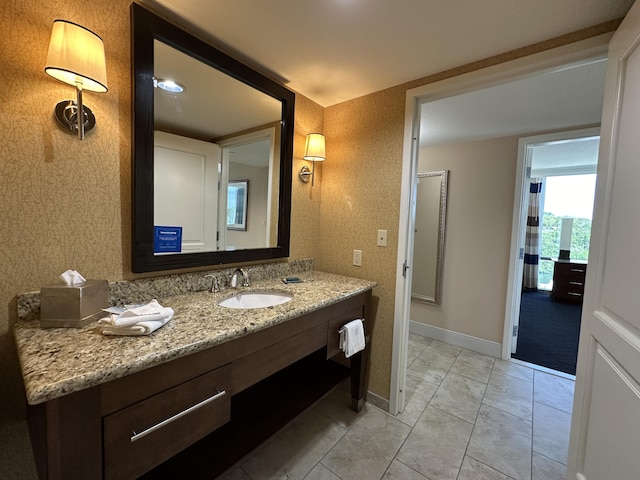 bathroom featuring baseboards and vanity