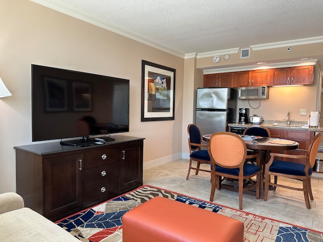 living room featuring a textured ceiling, crown molding, and sink