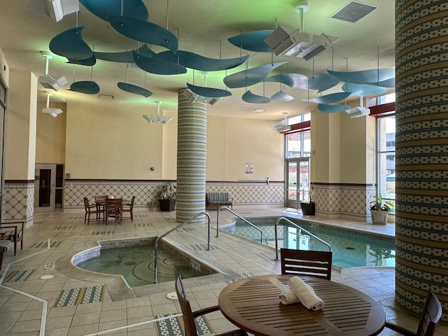 view of swimming pool with an indoor in ground hot tub