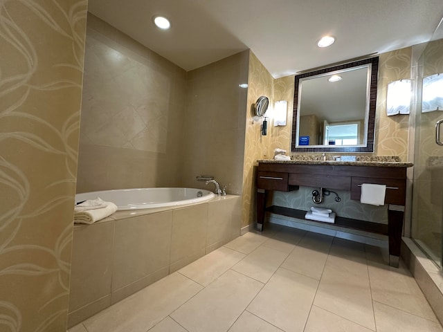 bathroom featuring tile patterned flooring, vanity, and plus walk in shower