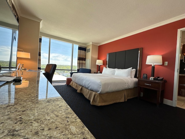 bedroom with access to outside, a textured ceiling, a wall of windows, and ornamental molding