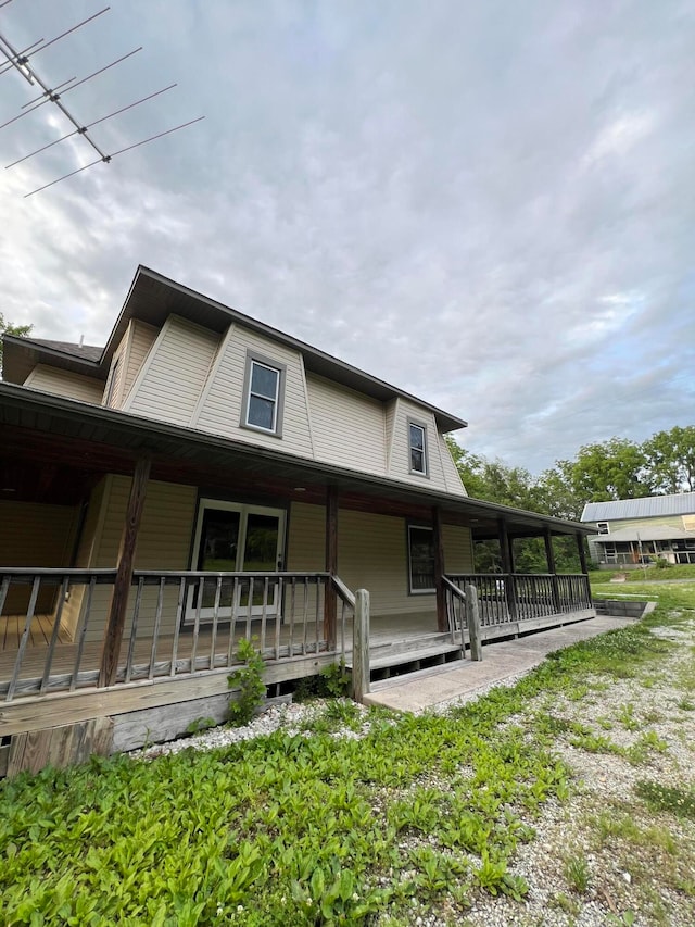 back of house with covered porch