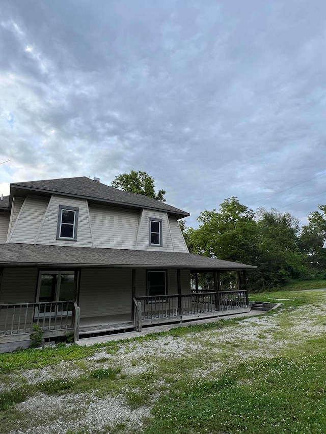 back of house with a lawn