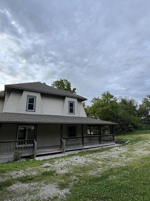 429 S Eagle Ave, Norwood, MO 65717 - rear view of property featuring a shingled roof, covered porch, and a yard