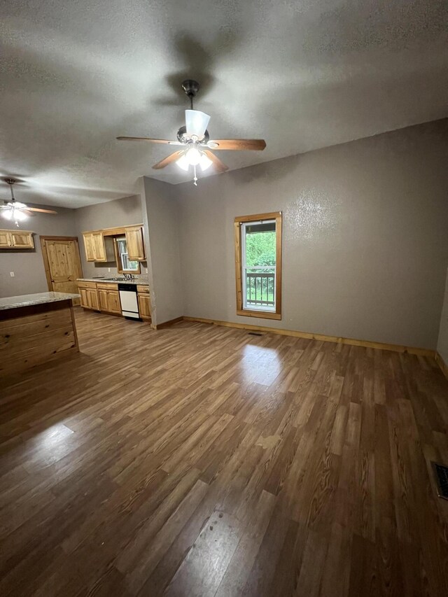429 S Eagle Ave, Norwood, MO 65717 - unfurnished living room with a textured ceiling, dark wood finished floors, visible vents, baseboards, and ceiling fan