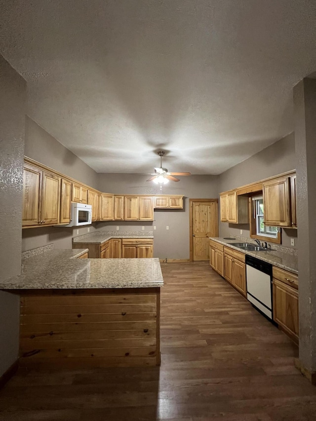 429 S Eagle Ave, Norwood, MO 65717 - kitchen featuring a peninsula, dark wood-style floors, a ceiling fan, white appliances, and light stone counters