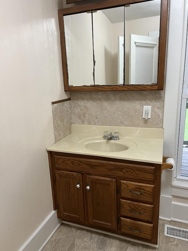 429 S Eagle Ave, Norwood, MO 65717 - bathroom with tile patterned floors, tasteful backsplash, baseboards, visible vents, and vanity