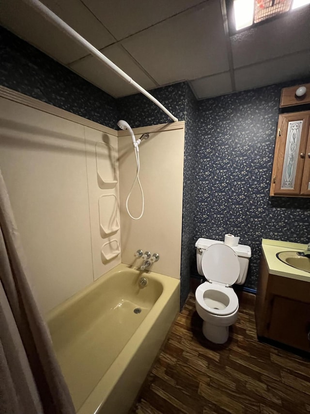 429 S Eagle Ave, Norwood, MO 65717 - full bathroom with wood finished floors, wallpapered walls, vanity, tub / shower combination, and toilet