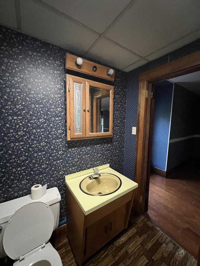 429 S Eagle Ave, Norwood, MO 65717 - bathroom featuring wallpapered walls, a paneled ceiling, wood finished floors, and toilet
