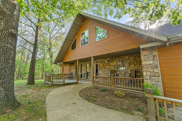24265 Raintree Ln, Shell Knob, MO 65747 - view of front of home featuring a wooden deck and stone siding