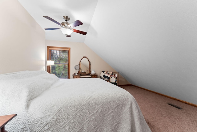 bedroom with ceiling fan, vaulted ceiling, and carpet