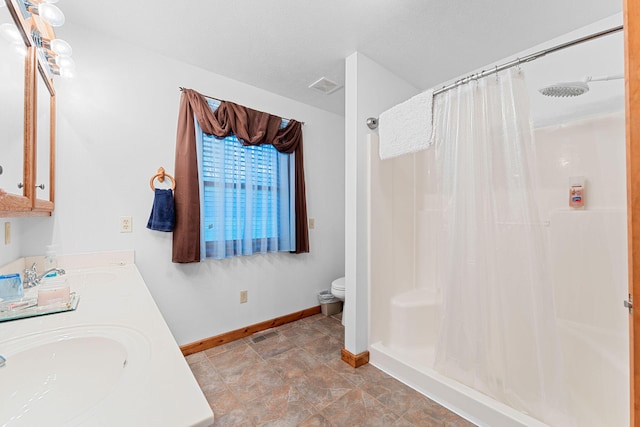 bathroom with vanity, toilet, and a shower with curtain