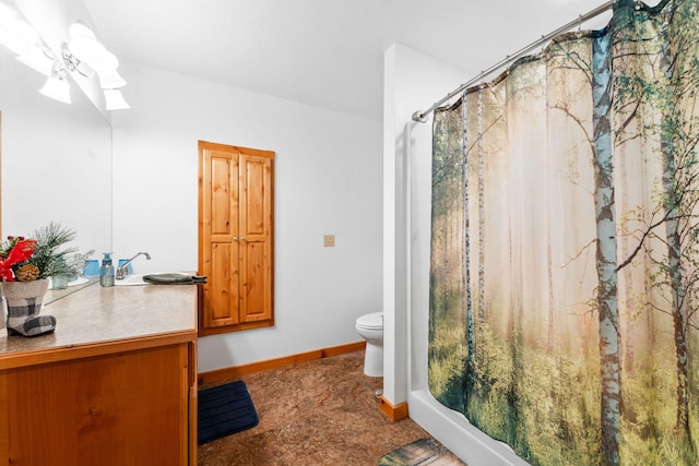 bathroom with curtained shower, a skylight, vanity, and toilet