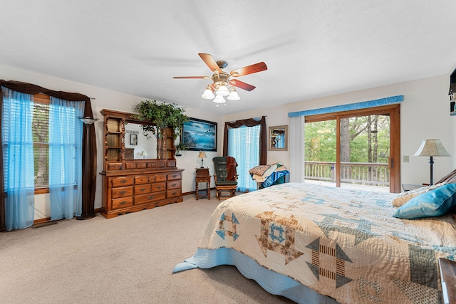 carpeted bedroom with ceiling fan and access to outside