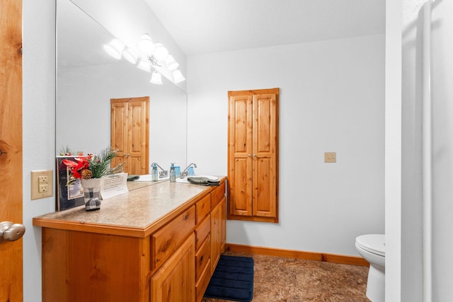 24265 Raintree Ln, Shell Knob, MO 65747 - bathroom featuring baseboards, toilet, and vanity