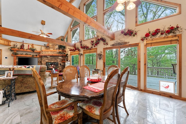 dining room featuring high vaulted ceiling, ceiling fan, and a healthy amount of sunlight