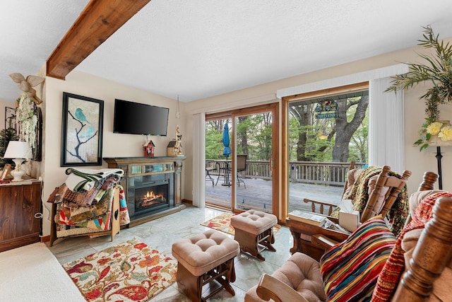 24265 Raintree Ln, Shell Knob, MO 65747 - living room with baseboards, a glass covered fireplace, beam ceiling, and a textured ceiling