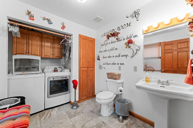 24265 Raintree Ln, Shell Knob, MO 65747 - washroom featuring baseboards, visible vents, washer and clothes dryer, and cabinet space