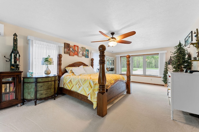 carpeted bedroom featuring a textured ceiling and ceiling fan