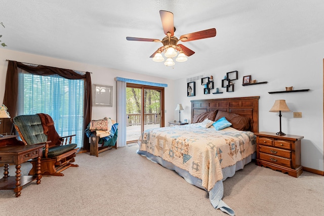 carpeted bedroom featuring access to outside, a textured ceiling, and ceiling fan