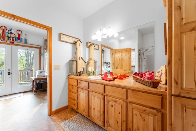 bathroom with vanity, a shower with shower curtain, and french doors