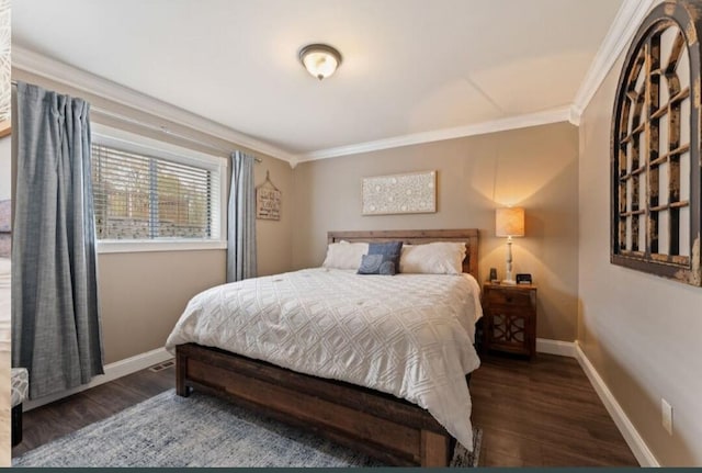 bedroom featuring baseboards, ornamental molding, and wood finished floors