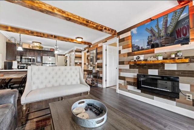 living room with crown molding, wooden walls, and dark hardwood / wood-style floors