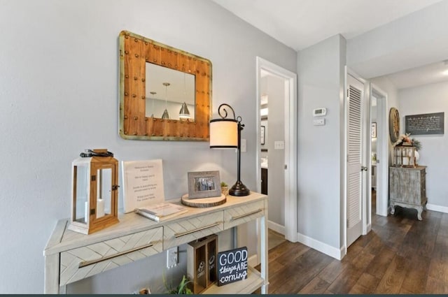 hallway with wood finished floors and baseboards