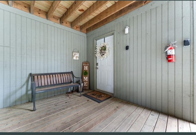 entrance to property featuring a wooden deck