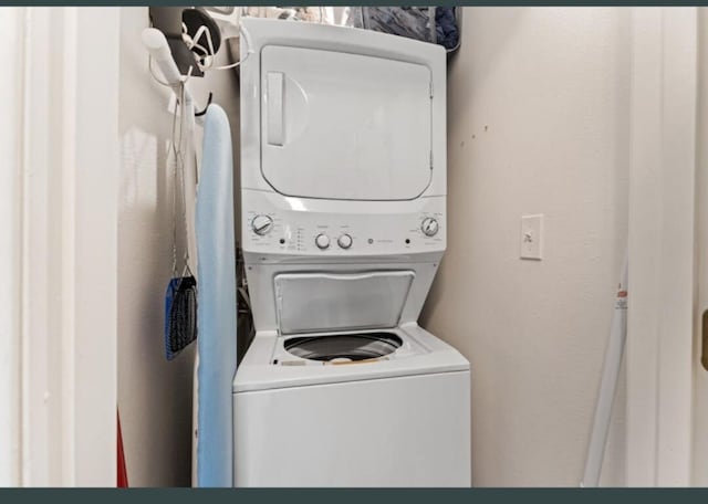 laundry area with stacked washer and dryer