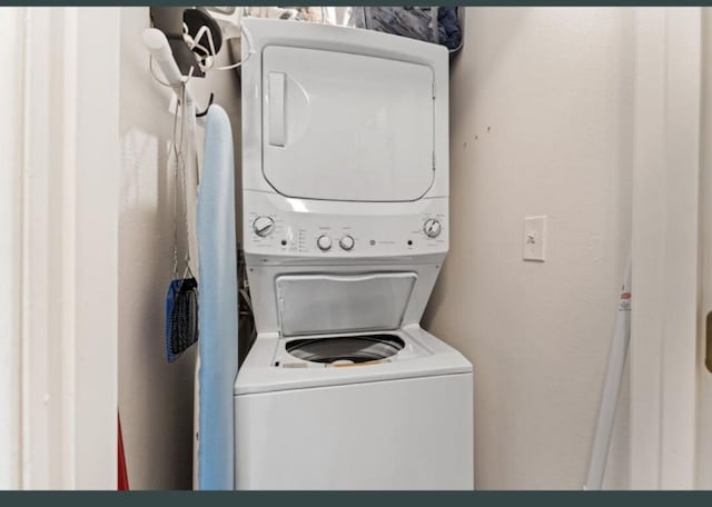 laundry area with stacked washer and dryer and laundry area