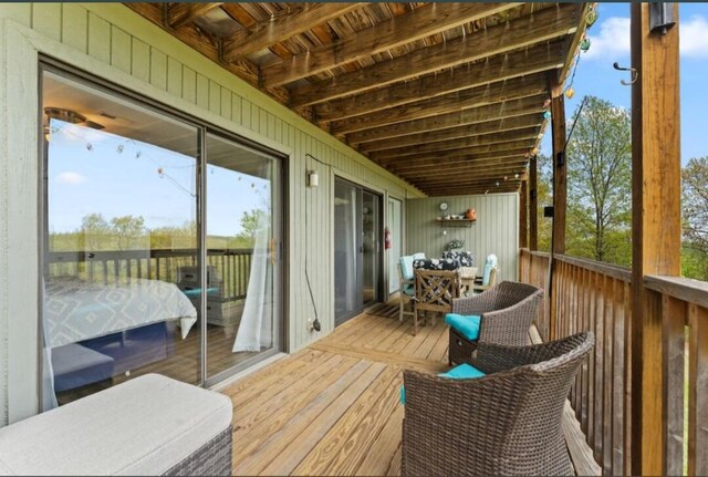 wooden terrace with outdoor dining space