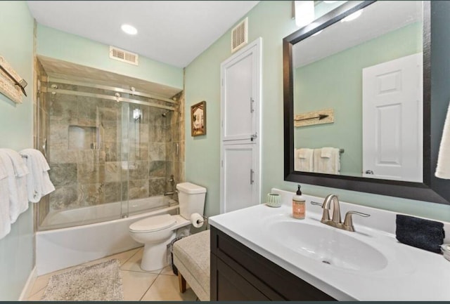 full bathroom featuring vanity, tile patterned flooring, toilet, and combined bath / shower with glass door