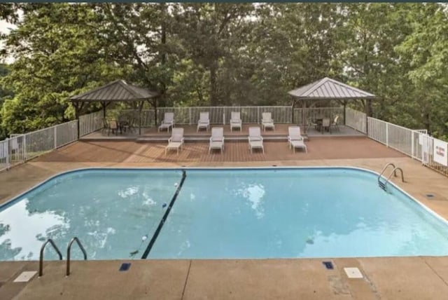 view of swimming pool with a gazebo and a patio