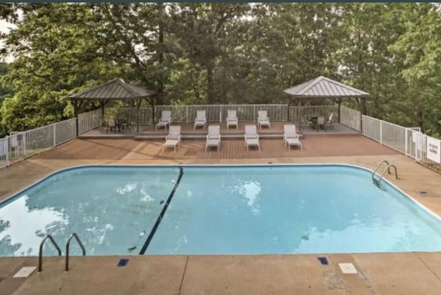 pool featuring a gazebo and fence