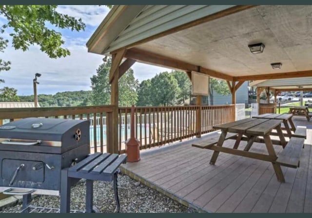 deck with area for grilling and outdoor dining space