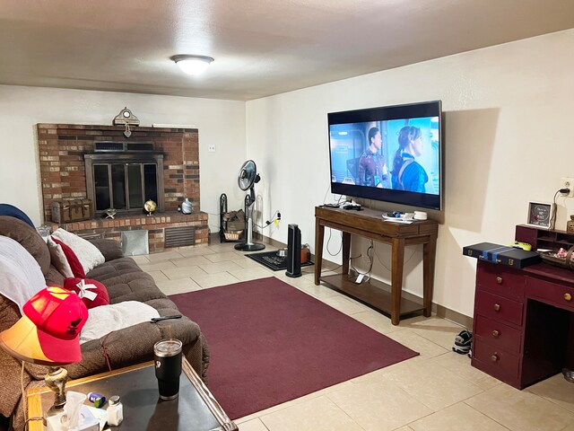 living room with a fireplace and light tile patterned floors