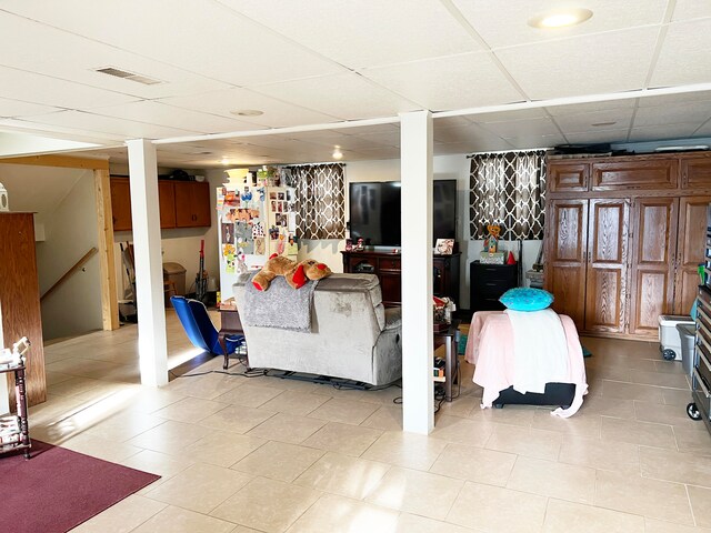 interior space with a paneled ceiling