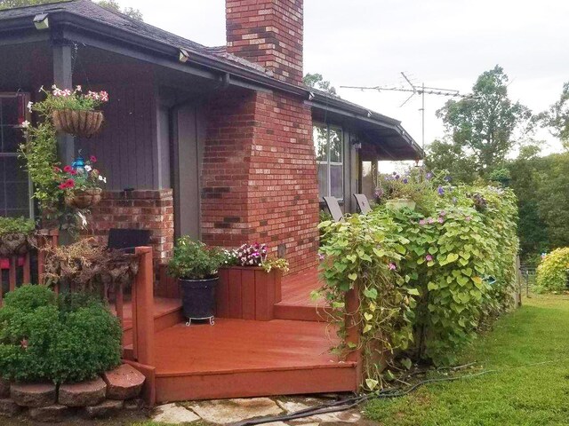 view of side of home with a wooden deck