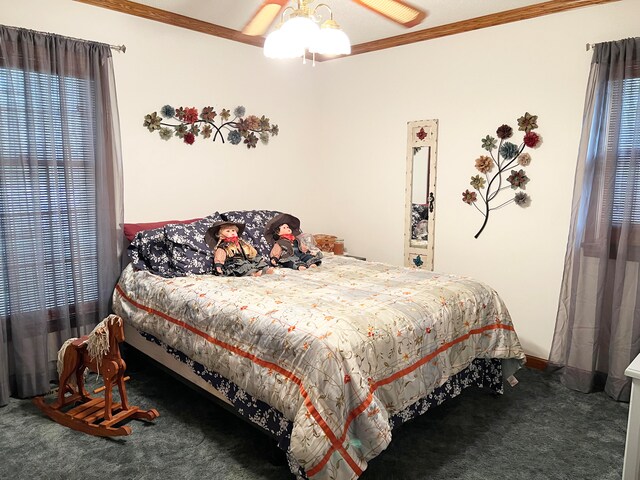 carpeted bedroom with ceiling fan and crown molding