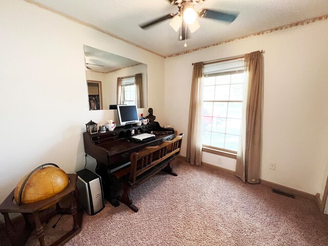 carpeted office space with ceiling fan