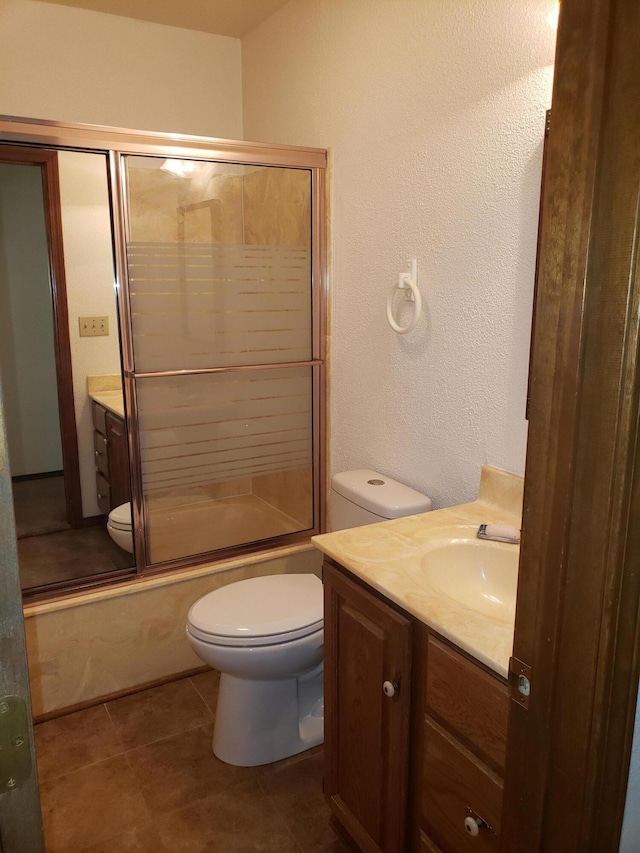 full bathroom featuring shower / bath combination with glass door, vanity, and toilet