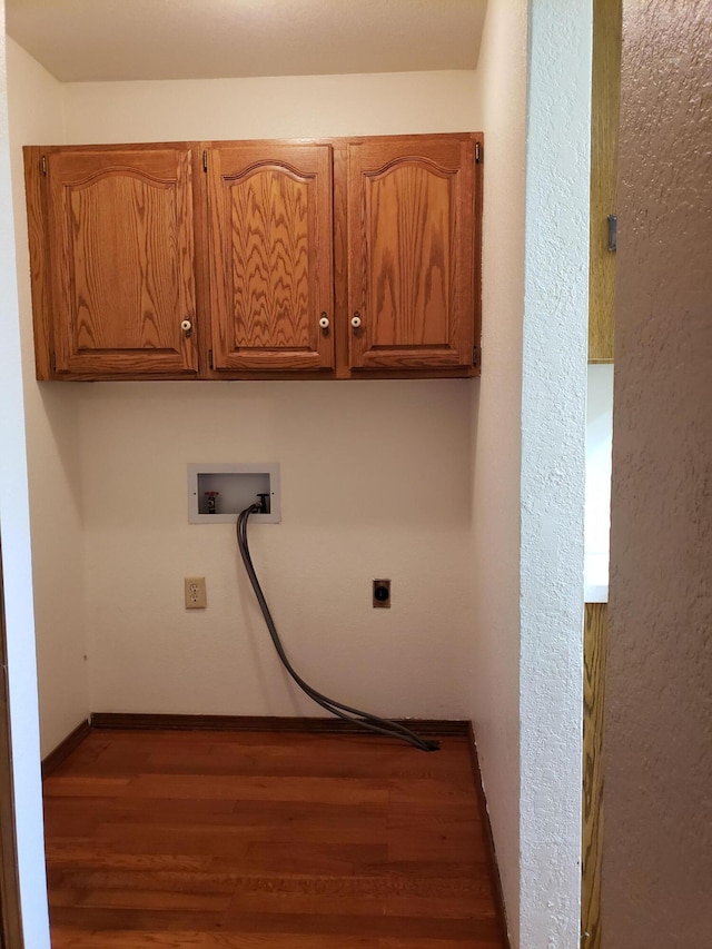 washroom with cabinets, hookup for a washing machine, dark hardwood / wood-style floors, and electric dryer hookup